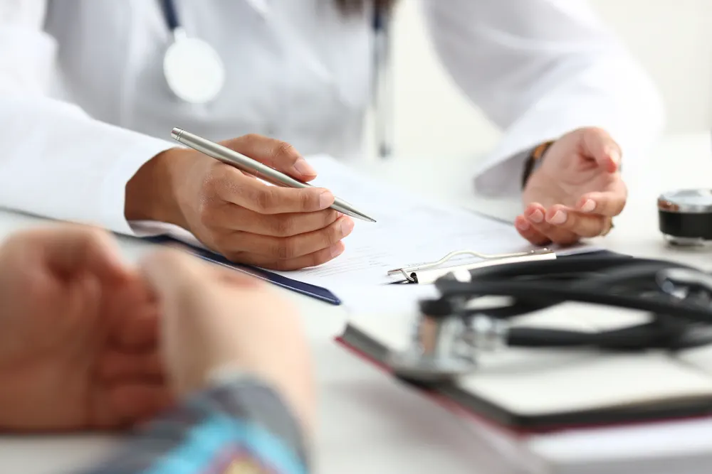 Doctor reviewing a patient's medical paperwork