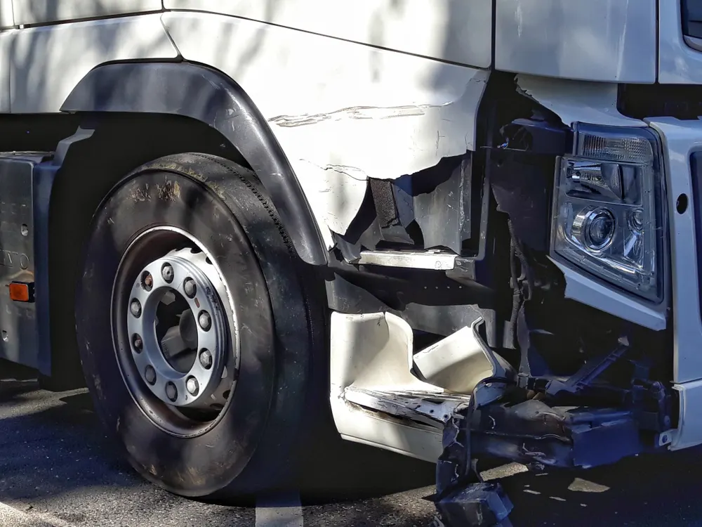 Close-up of a semi-truck's damaged front end after a collision