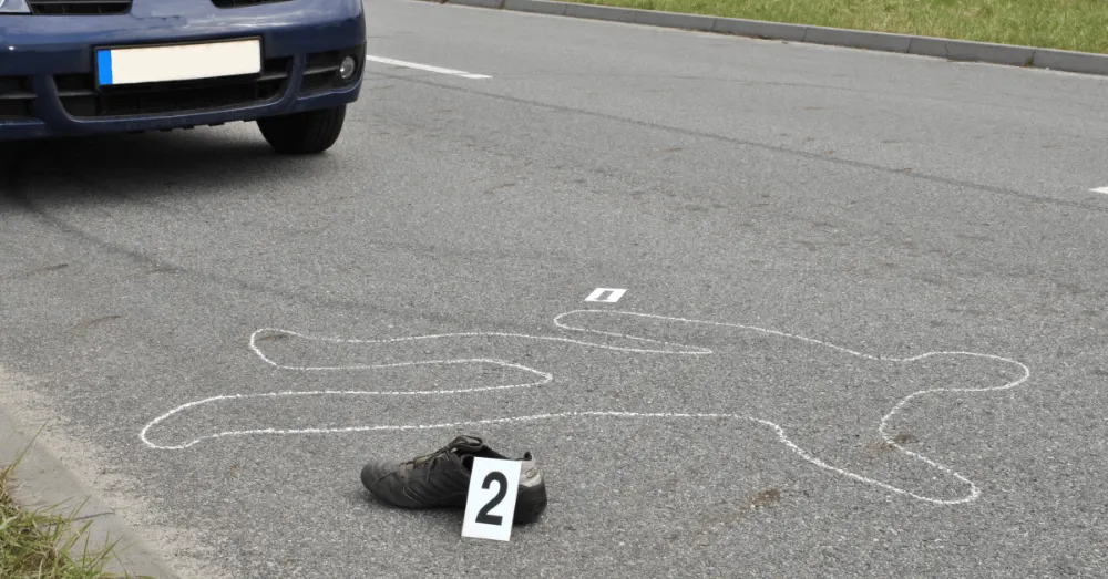 Chalk outline and evidence marker at the scene of a hit-and-run accident